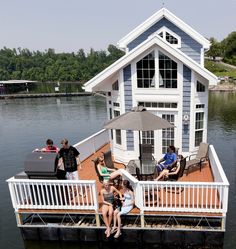 some people are sitting on a dock by the water