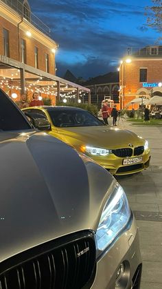 several cars parked in front of a building at night