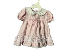 Vintage pink frilly baby dress, tag says Alexis, sz 9 mos, 65% polyester 35% cotton. Dress buttons in the back, white lace trim. Dress is in great condition. Cute Vintage Dress With Lace Trim For Summer, Cute Vintage Dress With Ruffles For Spring, Cute Summer Vintage Dress With Lace Trim, Cute Vintage Summer Dress With Lace Trim, Cute Spring Vintage Dress With Ruffles, Cute Vintage Dress With Lace Trim For Spring, Cute Pink Dress With Lace Collar, Spring Dress With Peter Pan Collar For Dress-up, Cotton Baptism Dress With Lining