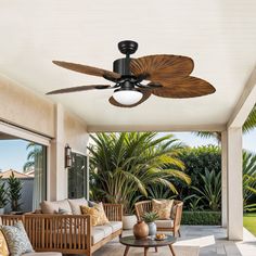 an outdoor living room with furniture and fan