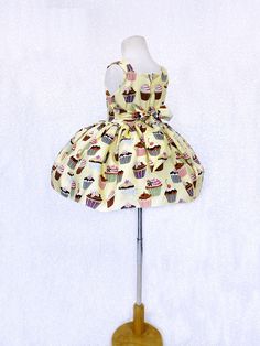 Perfect for photoshoots, pageants, birthdays, or to celebrate any holiday! Knee length dress made out cupcake patterned cotton. Bodice is sleeveless with a zipper on the back. On each side of the waist, there's attached ribbon that can be tied in the back into a bow. Underneath skirt is a layer of lining with crinoline attached to give the bottom shape. The dress is meant to be knee length. *Mannequin has petticoat to show detail. !PETTICOAT NOT INCLUDED! LINK TO PURCHASE PETTICOAT: https://www. Spring Sleeveless Pageant Dress, Sleeveless Spring Pageant Dress, Sleeveless Princess Pageant Dress, Princess Sleeveless Pageant Dress, Fitted Sleeveless Princess Pageant Dress, Sweet Sleeveless Party Dress, Fitted Sleeveless Pageant Dress With Ruffles, Sleeveless Summer Pageant Dress, White Sleeveless Princess Dress For Birthday