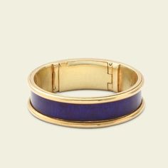 This unassuming gold and blue enamel ring is so much more than meets the eye. Dating to the Regency period, this elegant piece is mourning ring engraved with the following details: "J. D. died 24th May 1825 Aged 84." The interior golds a hinged locket which once would have held plaited hair of the deceased but is now empty. This style of concealed locket mourning ring is quite unusual and very very special. It is a size 6 and cannot be resized. Gold Interior, Gold And Blue