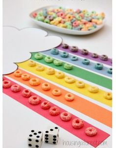 a paper plate with doughnuts on it sitting next to a rainbow colored apple