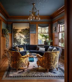 a living room filled with furniture and a painting on the wall