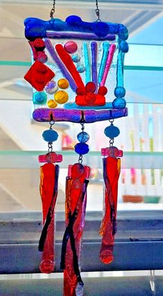 a colorful wind chime hanging from a window