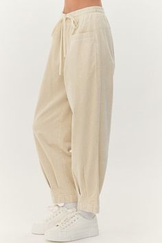 Cream cotton, drawstring pants with an elastic waistband and front pockets, pleat detail at the bottom. Sizes S, M and L Fabric: 100% cotton Fall Cotton Straight Sweatpants, Cotton Straight Sweatpants For Fall, Relaxed Cotton Wide-leg Bottoms, Straight Cotton Sweatpants For Fall, Spring Loungewear Harem Pants With Side Pockets, Relaxed Cotton Wide-leg Pants, Cotton Wide-leg Pants With Ribbed Waistband, Spring Side Pockets Harem Pants For Loungewear, Spring Harem Pants With Side Pockets For Loungewear