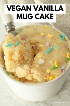 vegan vanilla mug cake in a white bowl with sprinkles on top