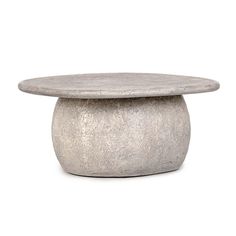 a round concrete table with a white background