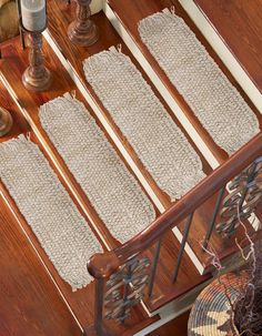 a wooden table topped with lots of white rugs