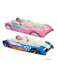 two children are sleeping on an inflatable toy car that is pink and blue