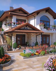 a large house with flowers in the front yard