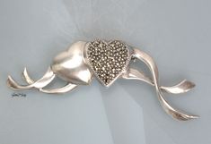 "Vintage designer JJ sterling silver 925 two Hearts pin/brooch. It is in very good condition, new old stock. It measures 2 5/8 inches long and 7/8\" tall. The weight of it is 0.4 oz. It is quality marked JJ Sterling. We combine shipping, If you want to take advantage of the reduced shipping you must contact us before you pay for your items so we can send you a corrected invoice. Thank You for visiting our Etsy store https://www.etsy.com/shop/VictoryIssweet !" Silver Heart-shaped Brooch For Valentine's Day, Silver Heart Brooch For Valentine's Day, Elegant Silver Heart Brooch, Elegant Silver Heart-shaped Brooch, Elegant Silver Heart-shaped Brooches, Elegant Silver Heart Brooches, Valentine's Day Silver Heart Brooch, Silver Heart Brooches For Gift, Silver Brooches For Anniversary On Valentine's Day