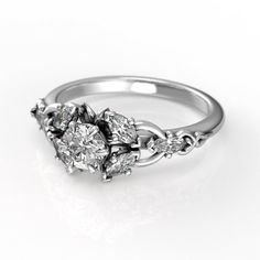 a three stone diamond ring on a white background