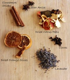 the ingredients for an orange spice recipe on a cutting board with cinnamons, star anise, dried orange slices, cloves, lavender and star anise