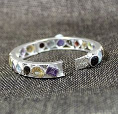 Wedding Jewelry Eternity Bangle Bracelet Clutch Lock Vibrant Gemstone 925 Sterling Silver Jewelry Engagement Gift Valentine Gift ,This Clutch lock Bangle cuff is made of solid 925 Sterling Silver studded with Genuine semi precious gemstones : Garnet, Amethyst, Citrine, Peridot , Smoky Quartz .They give a joyous brilliant aura to the jewelry piece .This simple but eye catcher bangle with is prominent multi color gemstones . SKU - ETB1003 Style - multi stone bangle Gemstone - multi stone Metal - 9 Stone Bangle, Gift Valentine, Anniversary Present, Hand Jewelry, Nature Bracelets, Valentine Gift, Dream Jewelry, Multi Stone, Sterling Silver Studs