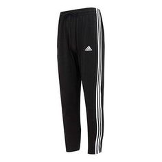 The adidas Logo Essentials Single Jersey Tapered Open Hem 3Stripes Pants is the perfect combination of style and comfort. Crafted with a tapered open hem and signature 3-Stripes, this adult-sized pant is designed to keep you looking and feeling your best. The black and white colorway is inspired by the classic adidas look, making it the perfect addition to your wardrobe. Whether you're running errands or going for a jog, these pants are the perfect choice for any activity. Get the iconic adidas look with the Logo Essentials Single Jersey Tapered Open Hem 3Stripes Pants. (Men's) Adidas Sportswear Pants With Three Stripes, Adidas Three Stripes Pants, Sports Sweatpants With Three Stripes, Sportswear Pants With Three Stripes Branding, Sportswear Pants With Three Stripes For Loungewear, Sporty Lounge Pants With Three Stripes, Sporty Loungewear Pants With Three Stripes, Athleisure Pants With Three Stripes For Loungewear, Athleisure Loungewear Pants With Three Stripes