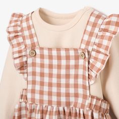 Nothing says southern chic like gingham. This adorable set is made with stretch for easy wearing and features a ruffle sleeve for added cuteness. 97% Cotton 3% Spandex Adjustable straps Coconut buttons Machine wash normal, Do not bleach, Tumble dry normal, Iron medium, Do not dryclean Long Sleeve Ruffled Dress For Picnic, Gingham Cotton Sets With Long Sleeves, Gingham Cotton Set With Long Sleeves, Cute Plaid Sets For Spring, Playful Plaid Sets For Spring, Playful Long Sleeve Ruffled Sets, Cute Long Sleeve Gingham Dress, Gingham Cotton Long Sleeve Sets, Cute Plaid Cotton Sets