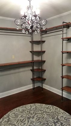 an empty room with shelves and a chandelier in the corner, which is also on pinterest