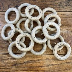 a pile of white rings sitting on top of a wooden floor