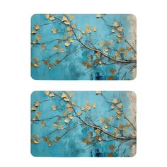 two pieces of blue and gold art with leaves on the top, one piece has an image of a tree