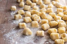 some kind of food that is on a wooden table in the process of being made