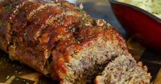 a meatloaf is cut into pieces on a cutting board