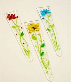 three pieces of glass with flowers on them