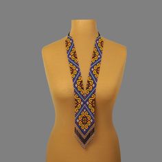 "A yellow and blue necklace is a stylish and original jewelry. A seed bead necklace will make you more tender and sophisticated. An elegant necklace will be a wonderful birthday gift for your wife. Despite the size, the bead necklace is light.  A long necklace is a versatile accessory that can complement any outfit, regardless of style. All handmade jewelry in our assortment is unique. Each product has its style and original design. Nevertheless, many jewelry pieces are easily combined, creating an unforgettable image. ------------------ The hippie jewelry is one of the best gift ideas. At SweetBeadsIP, you will find a gift for everyone - a gift for a girlfriend, a gift for a mother, a gift for a sister, or a gift for a daughter. The necklace is made of colorful Czech beads carefully threa Yellow Bohemian Necklace With 108 Beads, Elegant Yellow Long Beaded Necklaces, Elegant Yellow Long Beaded Necklace, Elegant Long Yellow Beaded Necklace, Elegant Yellow Jewelry With Tiny Beads, Handmade Yellow Beaded Necklaces For Gifts, Handmade Yellow Beaded Necklaces As Gift, Traditional Blue Beaded Necklace With Gold Beads, Blue Beads With Gold Details As A Gift