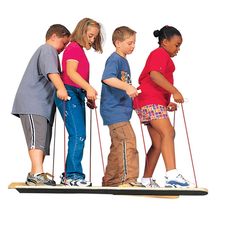 three children are standing on skis with poles attached to their feet and one child is holding the pole