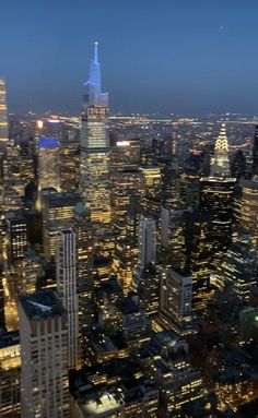 an aerial view of the city skyline at night from high up in the skyscrapers