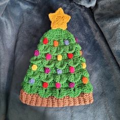 a crocheted christmas tree ornament on a jacket