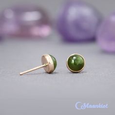 These Natural Jade Stud Earrings feature lovely 6 mm green jade cabochons. These matched green stones are carefully set in gold filled bezels here in our studio. These bezels are firmly soldered to posts and tumble polished for hours to a high shine. Jade has been used from prehistoric periods for hardstone carving. Material - gold filled post, gold filled bezel, 6 mm green jade cabochons, gold filled earring backs Dimensions - Cabochons measure 6 mm in diameter, Stud posts are 11 mm long in a 2 Green Earrings With Bezel Setting For May Birthstone, Green 14k Gold Earrings With Bezel Setting, Prehistoric Period, Small Stud Earrings, Green Stones, Jade Earrings, Nephrite Jade, Small Earrings Studs, Gold Filled Earrings