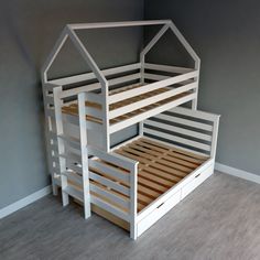 there is a bunk bed with two drawers underneath it and the bottom one has a house shaped roof