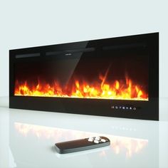 a remote control sitting on top of a table next to a wall mounted fire place