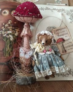 there is a stuffed bear that is sitting on the table next to an old fashioned hat