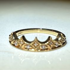 a gold crown ring sitting on top of a table