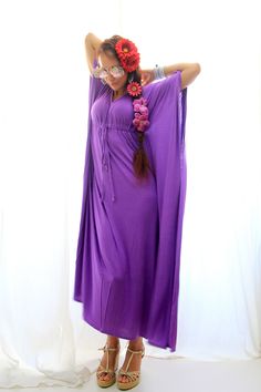 "Summer travel is a breeze when your go-to dress is a maxi kaftan in super soft, rayon jersey knit fabric. Add metallic sandals and sparkly jewelry to get glam in a snap, or try it with earthy accessories for the perfect bohemian summer look. Subtle side slits from the knee down, keep movement in this kaftan easy and the fabric flowing. Available in a rainbow of colors. Shown in \"Cosmic Purple (new color!)\". Fit: -Available in sizes: S ( 2-4), M (6-8), L (10-12) , XL (14-16) , XXL (18-20) See Bohemian Stretch Dress For Beach Cover-up, Bohemian Long Stretch Dresses, Summer Stretch Maxi Dress For Beach, Bohemian Stretch Dresses For Vacation, Stretch Long Maxi Dress As Beach Cover-up, Stretch Long Maxi Dress For Beach Cover-up, Flowy Rayon Maxi Dress For Daywear, Stretch Maxi Dress For Summer Loungewear, Stretch Summer Maxi Dress