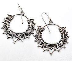 Mandala filigree sterling silver Indian silver drop hoop earrings. Good used condition with little to no signs of normal wear. Handmade soldering features. Beautiful patina. Acid tests positive for sterling silver. Earrings measure 1 and 3/4ths of an inch tall and 1 and 1/4 of an inch wide. Metal Hoop Earrings With Intricate Dangle Design, Ornate Silver Hoop Earrings With Intricate Design, Ornate Sterling Silver Hoop Earrings With Intricate Design, Small Hoop Sterling Silver Pierced Earrings, Silver Hoop Earrings With Intricate Design As Gift, Sterling Silver Hoop Jewelry With Intricate Design, Ornate Silver Hoop Jewelry, Ornate Metal Filigree Hoop Earrings, Sterling Silver Small Hoop Pierced Earrings