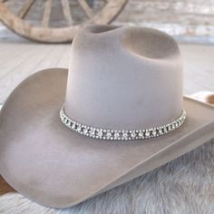 This rhinestone strand hatband comes with 3 layers of clear rhinestones set on silver metal. It is adjustable with a metal clasp in the back. Fits up to size 7 1/2 hat.  *This product is for 1 single hat band. Hat not included. Adjustable Western Jewelry For Party, Adjustable Western Style Party Jewelry, Adjustable Western Style Jewelry For Parties, Western Style Silver Party Jewelry, Western Silver Jewelry For Parties, Western Style Silver Jewelry For Party, Adjustable Silver Party Hat, Elegant Adjustable Top Hat For Rodeo, Adjustable Bling Hat For Country Events