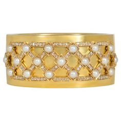 A Victorian gold hinged bangle bracelet with an applied lattice plaque of rose-cut diamonds and pearls, in 15k. England. nscribed, "Wedding present to Margaret Leicester Warren from the Tabley Tenantry, 1875" Inner circumference: 6.75" Margaret's father was George Warren, the second Baron de Tabley and a prominent liberal politician, and she would have grown up at the stately Palladian Tabley House in Cheshire. In 1875 she married Arthur Cowell-Stepney, 2nd Baronet, and this bracelet would have been a thoughtful gift from the tenants of Tabley. * Includes a letter of authenticity for insurance purposes * Free shipping * Please do not hesitate to request additional photos of specific details Diamond Cuff Bracelet, Diamonds And Pearls, Victorian Gold, Diamond Bangle, Pearl Diamond, Hinged Bangle, Love Ring, Gold Jewelry Fashion, Gold Pearl