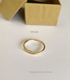 This solid 14k gold ring band is adjustable and make great gifts or Bridesmaids gifts.  I handcraft each one to order. If you are not sure of the persons rings size or your fingers well these are great rings and very comfortable.  The ring makes a great thumb ring because it can fit over your knuckle and then be adjusted a little smaller to fit your thumb snugly. These rings are solid 14k Gold and will come in the Gift box shown. If you would like something special please send me a note :)  Free Gold Thumb Rings For Women, Thumb Rings For Women, Stacking Rings Gold, Ankle Bracelets Gold, Gold Thumb Rings, Wide Gold Ring, Gold Stacking Rings, Open Cuff Ring, Round Wedding Band