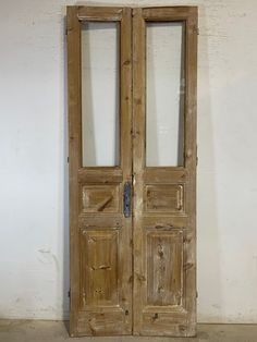 an old wooden double door with glass panels