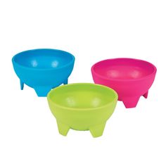 three different colored bowls sitting next to each other