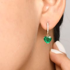 Real emerald heart shape dangling earrings gold | Natural 3CT heart emerald diamond dangling earring gold | Emerald cut emerald earring gold EARRING DETAILS : ✦  Earring type : Dangle Earrings ✦  Earring length : 30 MM ✦  Earring closure : Hoops lock ✦  Earring weight : 5-6 grams for the pair STONE DETAILS : ✦ Gemstone : Emerald ✦ Gemstone Type : Natural ✦ Gemstone Size : 7 MM ✦ Gemstone Shape :  Heart ✦ Number of gemstones : 2 ✦ Gemstone Weight : 3 Carats ✦ Gemstone Grade : AAA DIAMOND DETAILS Heart-shaped May Birthstone Earrings For Anniversary, Heart Shaped May Birthstone Earrings For Anniversary, Elegant Green Heart Cut Earrings, Formal Green Heart-shaped Earrings, Elegant Green Heart Earrings For Gift, Green Heart Earrings For Anniversary On Valentine's Day, Green Heart Earrings For Valentine's Day Anniversary, Green Heart-shaped Earrings For Anniversary, Elegant Green Earrings With Heart Charm