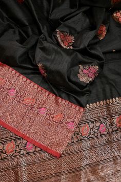 This latest collection is in a black and red color combination, a pure tussar silk banarasi saree with golden zari and meenakari work, and in an alluring meenar butta work on the body and traditional meenakari work on the pallu and the border and all over. Color: A shade of black and red color Technique: A pure and refined hand-done work of border with meenakari zari work and traditional meena butta work Fabric: Tussar Quality: IndyVogue's Assurance of Silk Mark Certification Note: Comes with contrasting color Meena brocade blouse piece.