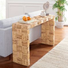 a living room with a couch, table and potted plant