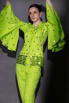 Neon green matka silk jacket with laser-cut acrylic glass and beaded embroidery. Comes with pant.
Components: 2
Pattern: Embroidered
Type Of Work: Laser-cut acrylic glass, Beads
Neckline: Lapel collar
Sleeve Type: Bell Sleeves
Fabric: Matka silk
Color: Green
Other Details: 
Length :
Jacket : 25 inches
Pant : 36 inches
Closure : Jacket - Front buttons
Occasion: Party - Aza Fashions Green Fitted Designer Pant Set, Festive Green Fitted Pant Set, Fitted Green Pant Set For Party, Green Fitted Pant Set For Party, Green Festive Pant Set For Spring, Green Sequin Sets For Spring, Green Pant Set For Spring Party, Spring Designer Party Sets, Designer Party Sets For Spring