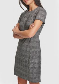 This posh A-line dress from Calvin Klein showcases a timeless houndstooth print. | Calvin Klein Women's Short Sleeve Printed A-Line Dress, 12 Classic Fitted Plaid Dress For Fall, Chic Calvin Klein Dresses For Fall, Short Sleeve Tweed Dress For Fall Formal Events, Classic Career Dresses For Fall, Elegant Plaid Dress For Work, Formal Short Sleeve Tweed Dress For Fall, Chic Plaid Midi Dress For Work, Classic Knee-length Plaid Dress, Calvin Klein Knee-length Dresses For Fall