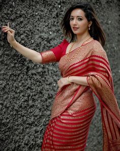 Red Silk Zari Woven Sari with running Jacquard blouse piece that can be custom made to an individual size. The saree is traditional and lightweight with copper color stripes all over and a grand border on both sides. The saree length is 5.50 mts and the  Jacquard woven blouse is 1mt with rich benarasi border for sleeves. Apt as wedding guest wear, engagement sari and reception attire. Suitable as festive wear and for all occasions. Customisation of the blouse can be chosen from the Variations Se Red Art Silk Pre-draped Saree With Self Design, Red Pre-draped Saree With Pallu For Eid, Red Pre-draped Saree With Cutdana For Celebrations, Traditional Red Pre-draped Saree For Festive Occasions, Bollywood Style Red Pre-draped Saree With Self Design, Red Pre-draped Saree For Eid Wedding, Red Chanderi Pre-draped Saree With Zari Weaving, Fitted Pre-draped Saree With Zari Weaving For Puja, Red Cutdana Choli For Traditional Ceremonies