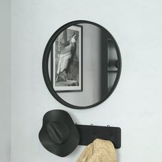 there is a mirror and hat on the wall